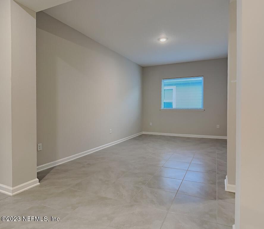 12032 Bridgehampton Road Jacksonville, FL 32218 - Photo 6 of 13 an empty room with a empty space and windows
