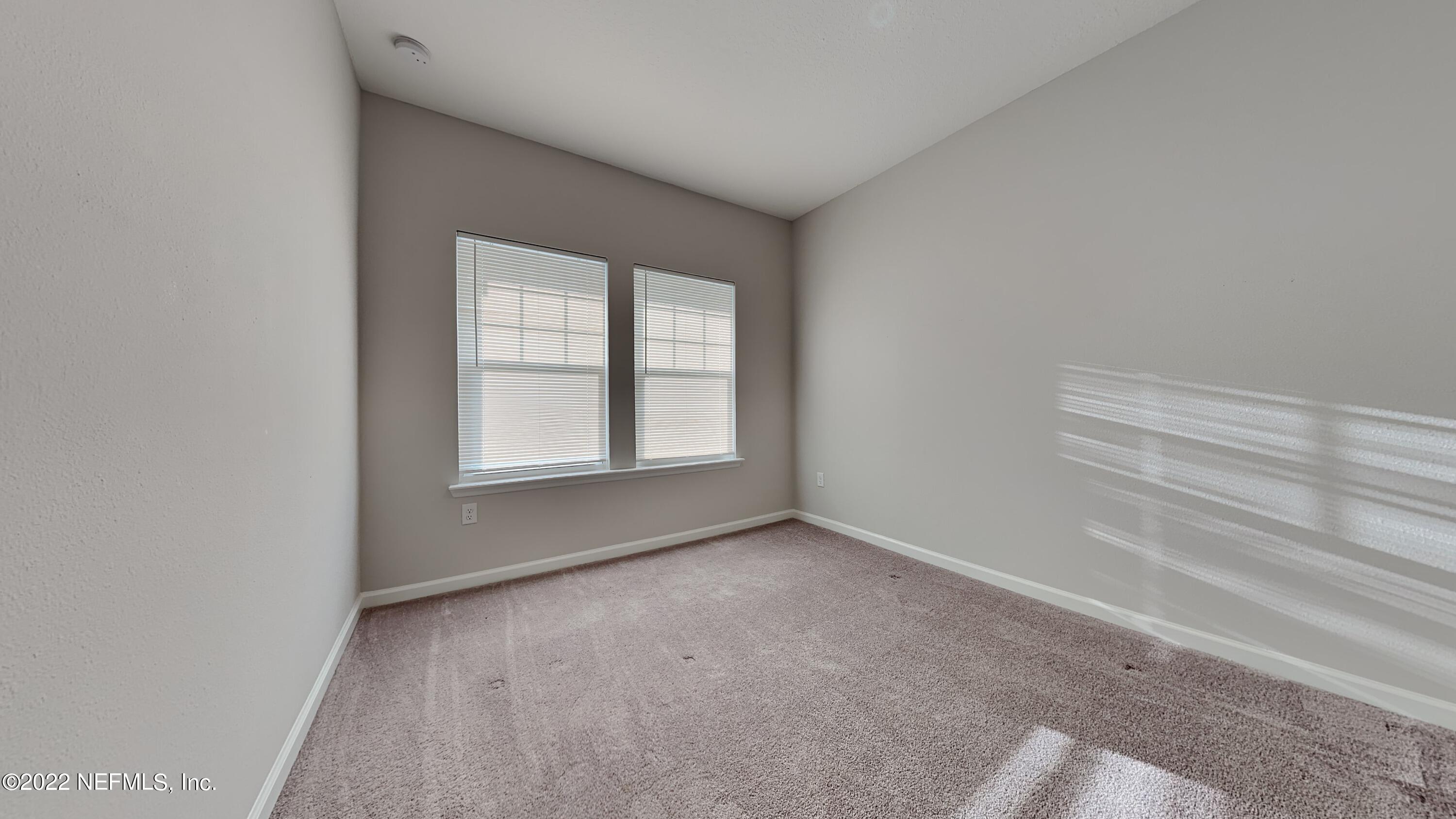 12032 Bridgehampton Road Jacksonville, FL 32218 - Photo 8 of 13 a view of an empty room with a window