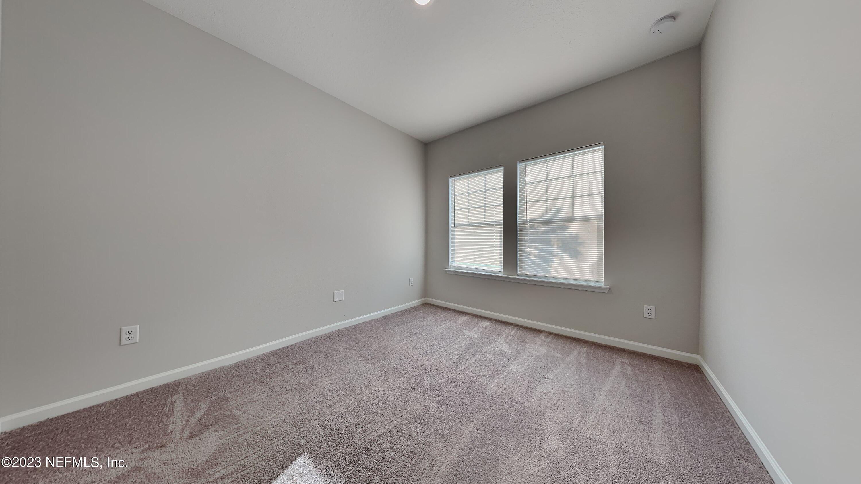 12032 Bridgehampton Road Jacksonville, FL 32218 - Photo 9 of 13 an empty room with windows