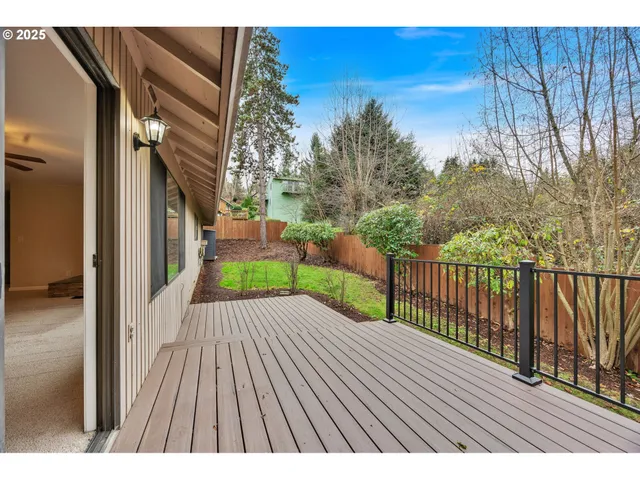 a view of backyard with a deck and wooden floor
