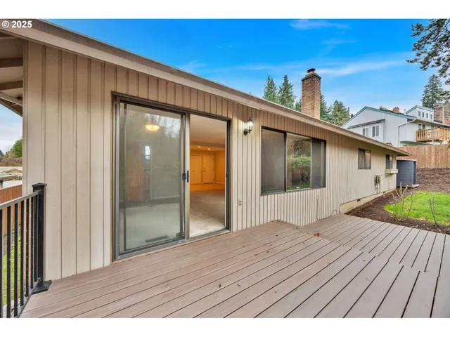 a view of backyard with small space and wooden fence