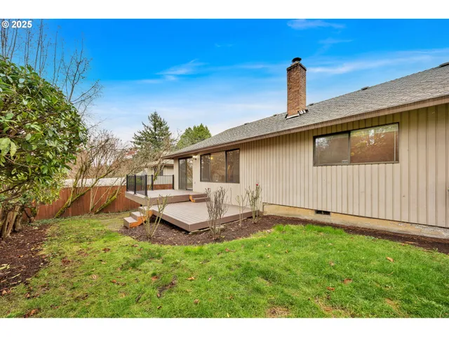 a front view of a house with a garden and yard