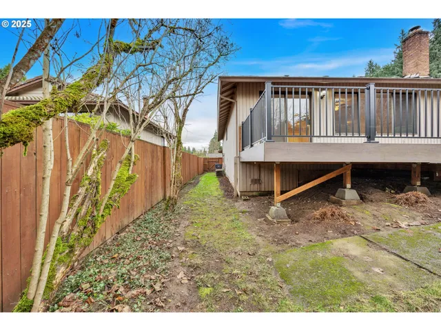 a view of wooden house with a wooden fence