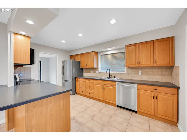 a kitchen with stainless steel appliances granite countertop a sink and cabinets