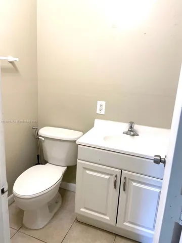 a white toilet sitting next to a bathroom sink