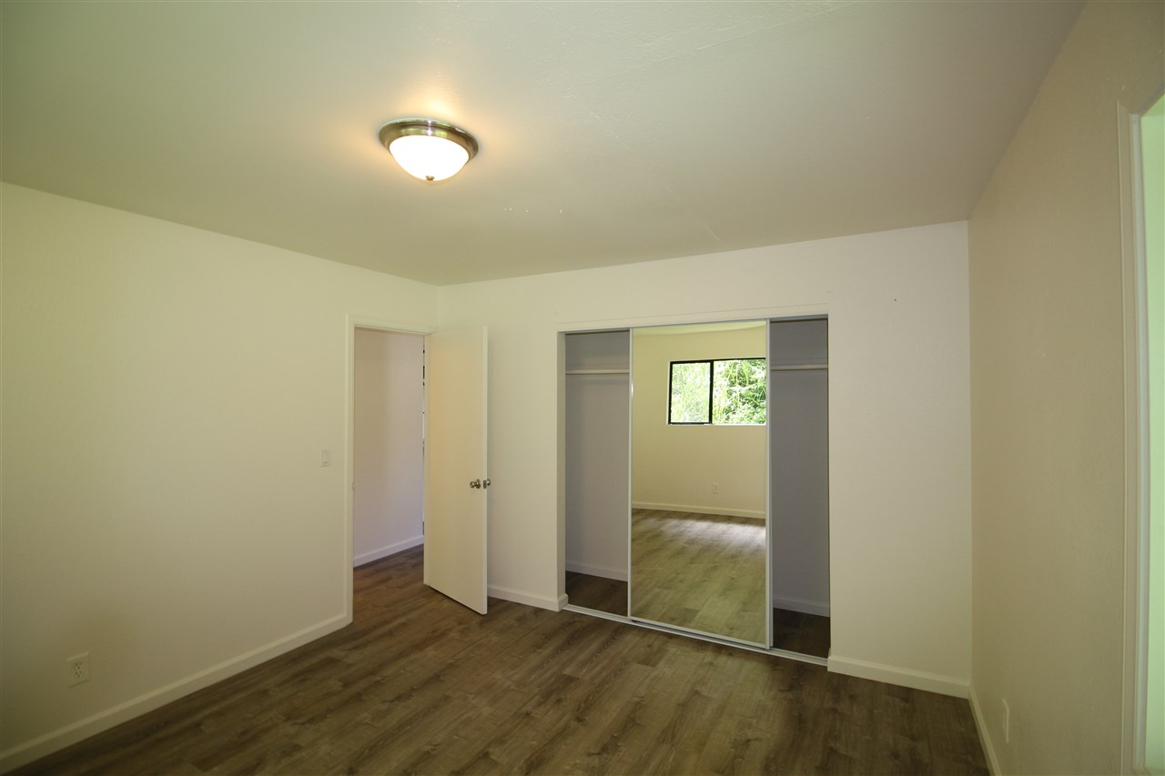 1000 Kauhikoa Road Haiku, HI 96708 - Photo 16 of 17 an empty room with wooden floor and windows
