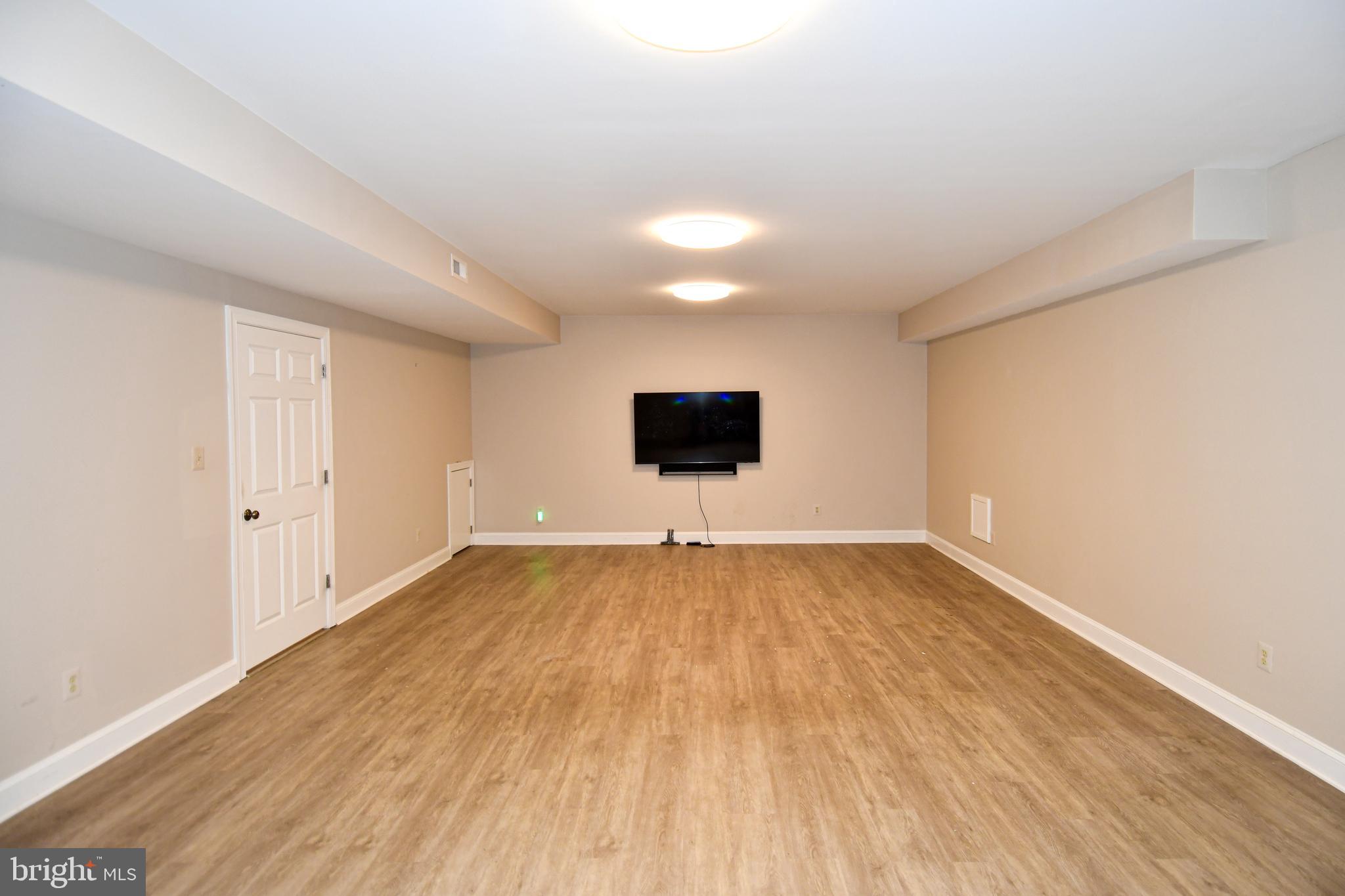 7808 Southdown Road Alexandria, VA 22308 - Photo 96 of 99 a view of an empty room with wooden floor and a window
