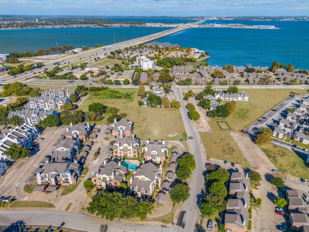 4434 Point Boulevard, Unit 208 Garland, TX 75043 - Photo 1 of 28 an aerial view of ocean and residential houses with outdoor space
