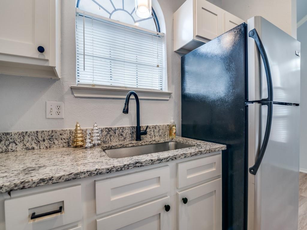 4434 Point Boulevard, Unit 208 Garland, TX 75043 - Photo 12 of 28 a bathroom with a granite countertop sink and a mirror