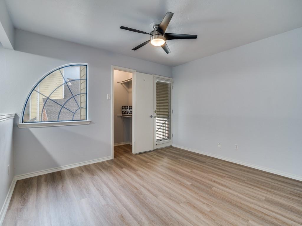 4434 Point Boulevard, Unit 208 Garland, TX 75043 - Photo 18 of 28 an empty room with wooden floor cabinet and windows