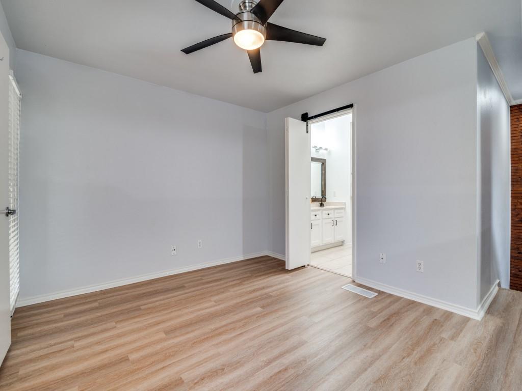 4434 Point Boulevard, Unit 208 Garland, TX 75043 - Photo 19 of 28 wooden floor in an empty room with a window