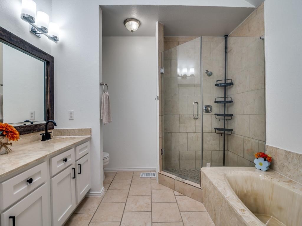 4434 Point Boulevard, Unit 208 Garland, TX 75043 - Photo 21 of 28 a bathroom with a tub sink and mirror