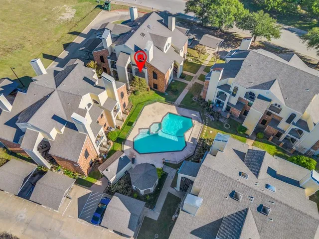 an aerial view of a house with a swimming pool patio and outdoor seating
