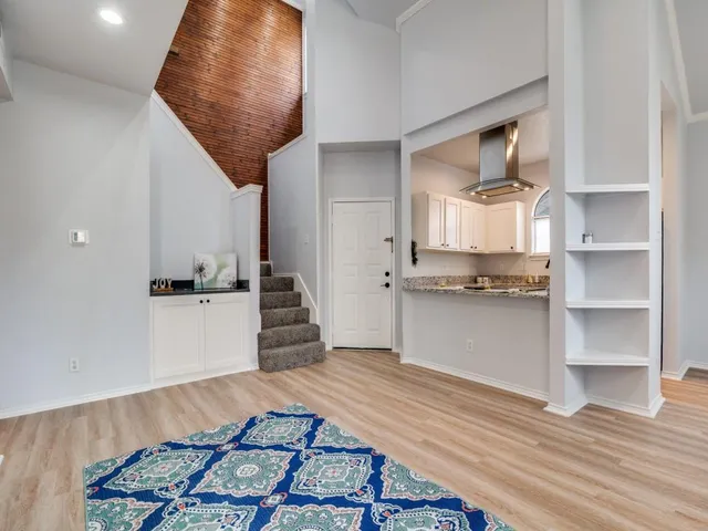 a kitchen view with wooden floor and electronic appliances