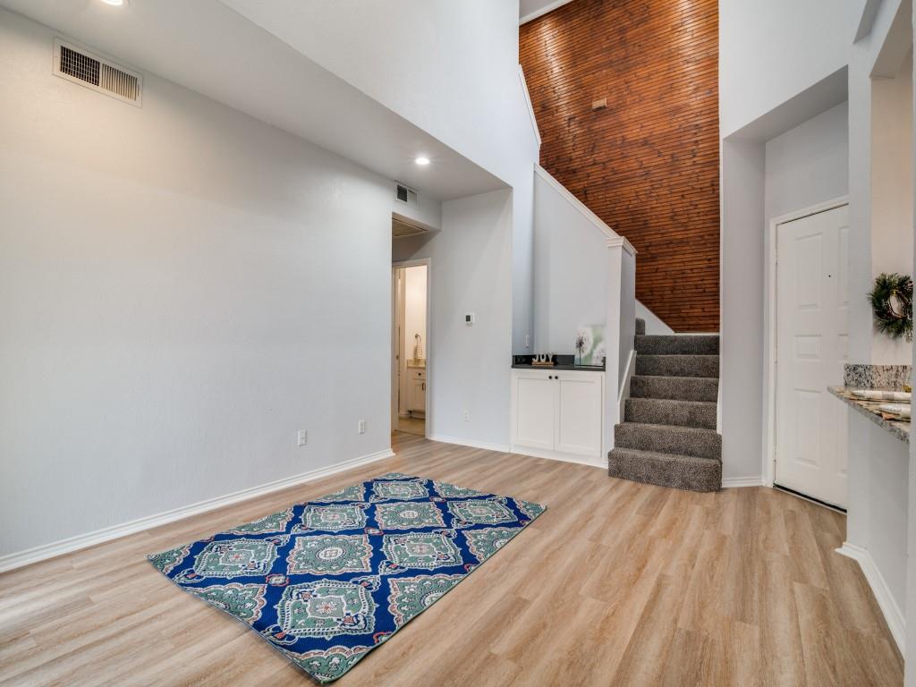 4434 Point Boulevard, Unit 208 Garland, TX 75043 - Photo 6 of 28 a view of a room with wooden floor and staircase