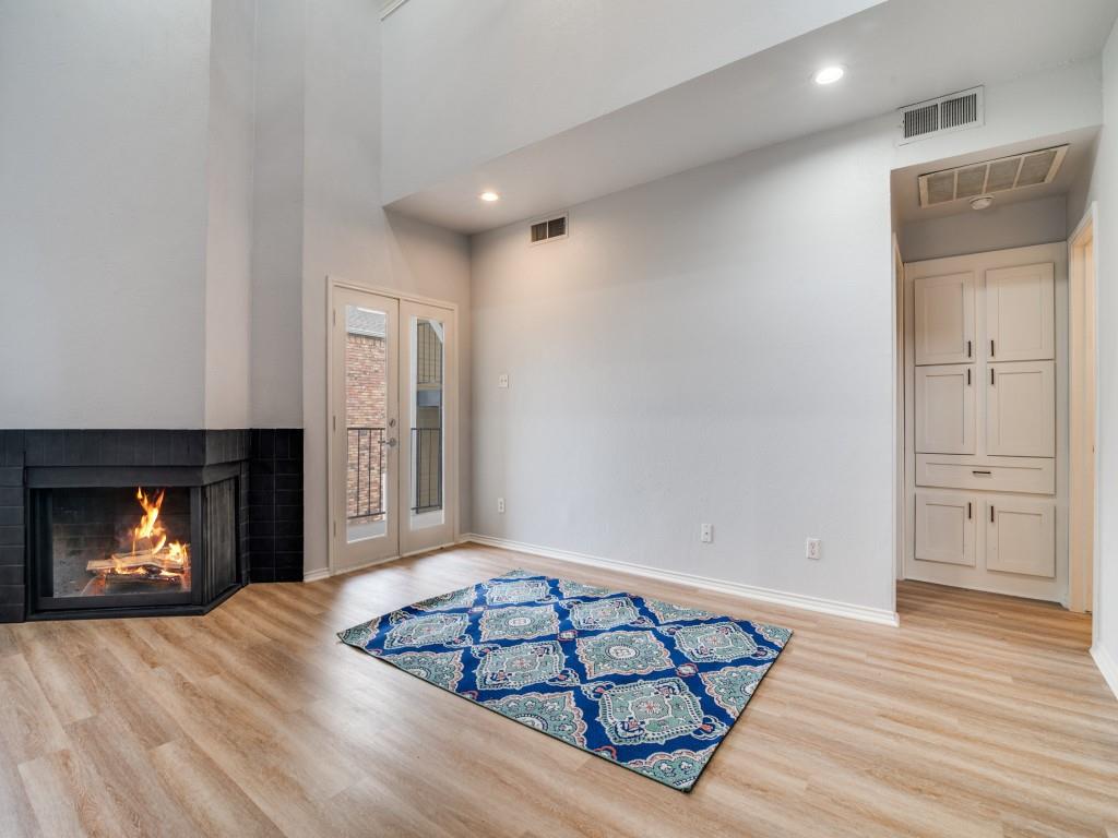 4434 Point Boulevard, Unit 208 Garland, TX 75043 - Photo 7 of 28 a view of a livingroom with wooden floor and fireplace