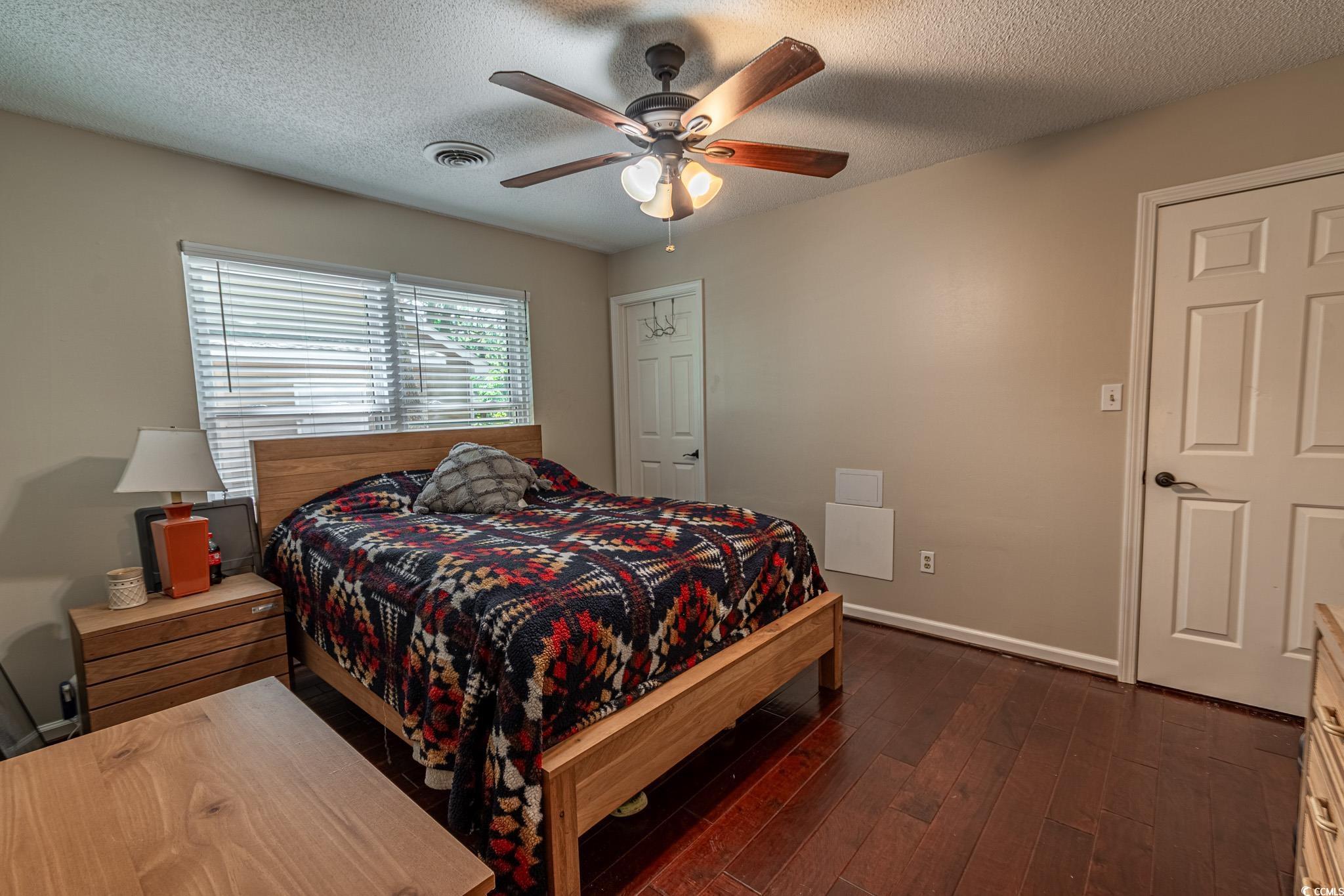 675 Mariner Avenue Murrells Inlet, SC 29576 - Photo 8 of 27 Bedroom with dark wood-type flooring, a textured ceiling, baseboards, and visible vents