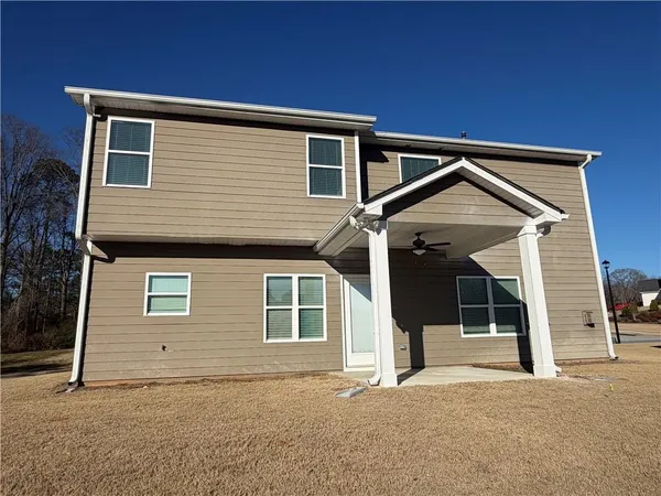 a view of a house with a backyard and garage