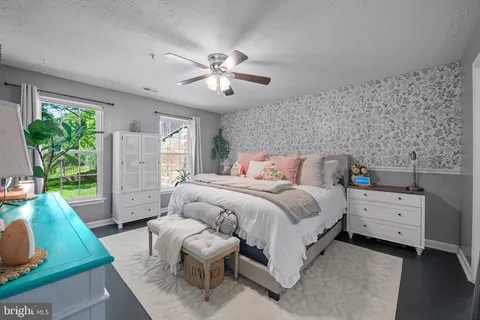 a spacious bedroom with a bed and a window