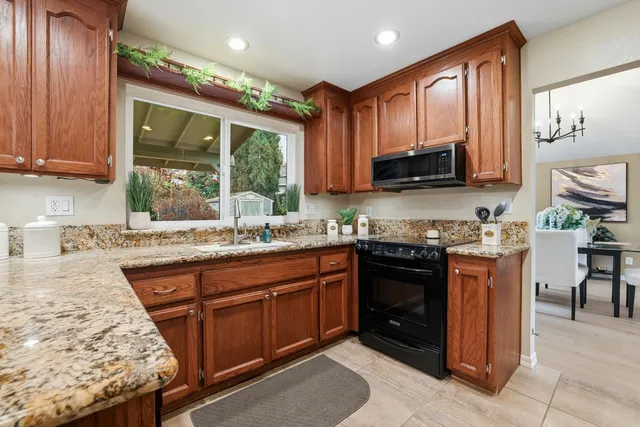 a living room with furniture a window and a lamp
