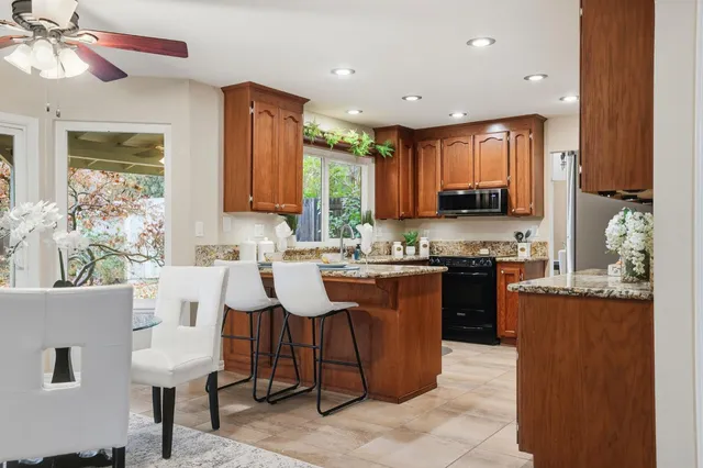 a bathroom with a granite countertop sink a toilet and a mirror