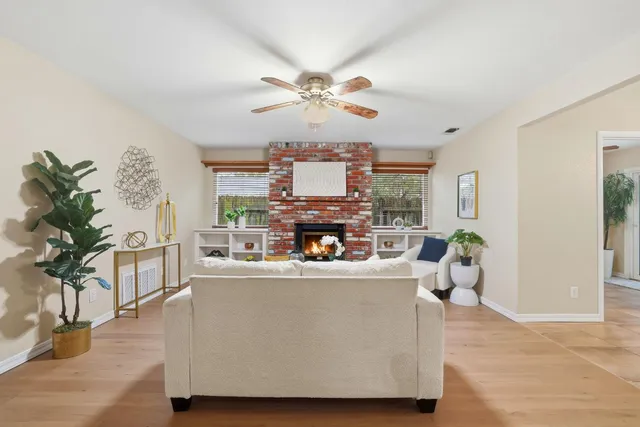 an aerial view of a house with a yard and trees all around