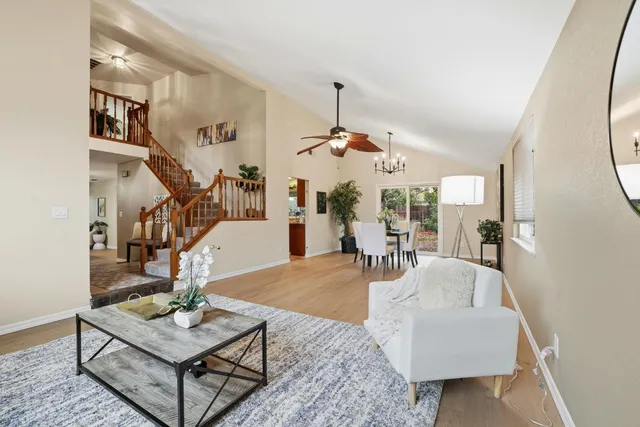 a living room with furniture and a chandelier