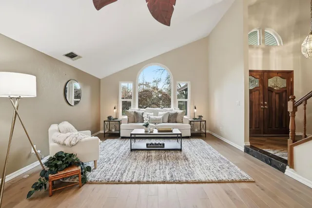 a view of a workspace with furniture and a window