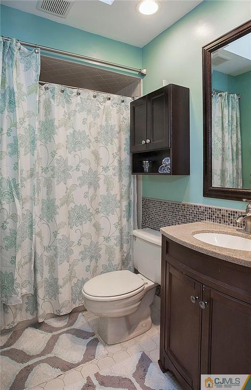 4606 Stonehedge Road Edison, NJ 08820 - Photo 22 of 24 a bathroom with a sink toilet and shower
