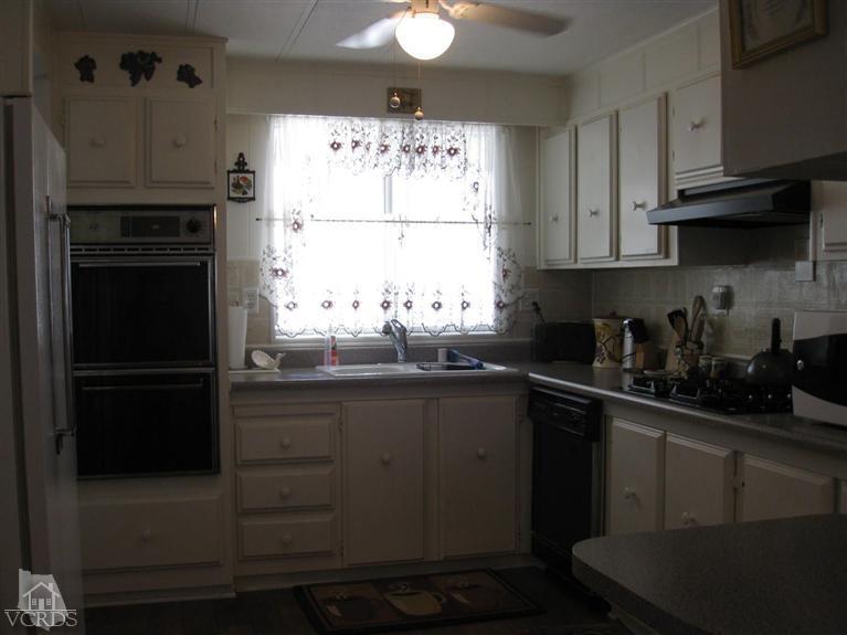 6480 Katherine Road, Unit 10 Simi Valley, CA 93063 - Photo 12 of 20 a kitchen with stainless steel appliances a refrigerator sink and cabinets