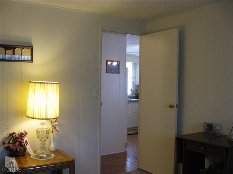 6480 Katherine Road, Unit 10 Simi Valley, CA 93063 - Photo 14 of 20 a view of room with bed and wooden floor