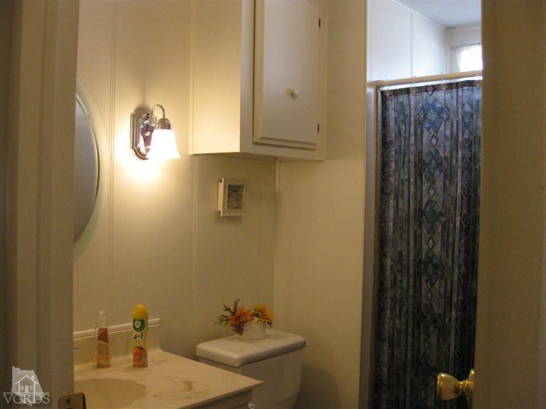 6480 Katherine Road, Unit 10 Simi Valley, CA 93063 - Photo 15 of 20 a bathroom with a sink and a mirror