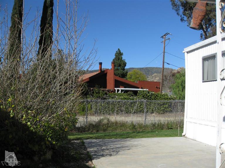 6480 Katherine Road, Unit 10 Simi Valley, CA 93063 - Photo 3 of 20 a front view of a house with a yard