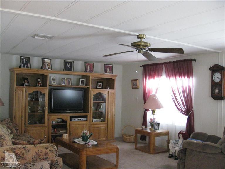 6480 Katherine Road, Unit 10 Simi Valley, CA 93063 - Photo 6 of 20 a living room with furniture and a flat screen tv