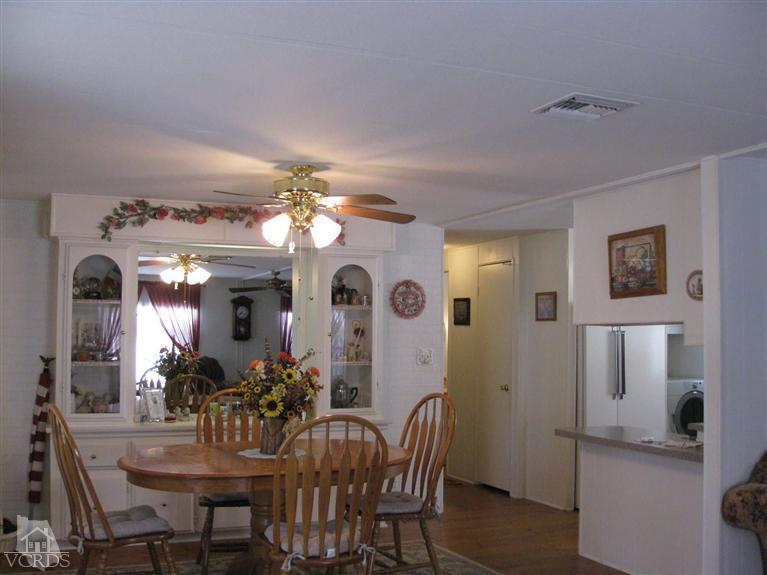 6480 Katherine Road, Unit 10 Simi Valley, CA 93063 - Photo 8 of 20 a view of a dining room with furniture and a chandelier
