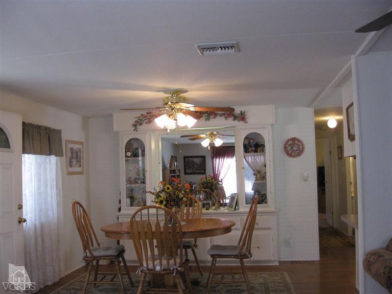 6480 Katherine Road, Unit 10 Simi Valley, CA 93063 - Photo 9 of 20 a view of a dining room with furniture and chandelier