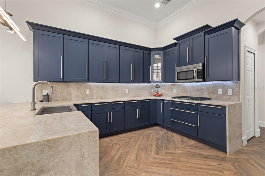 8351 Bowden Way Windermere, FL 34786 - Photo 10 of 71 a kitchen with stainless steel appliances granite countertop wooden cabinets a stove top oven a sink and dishwasher