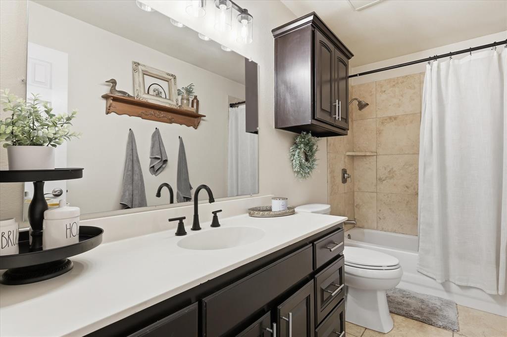 202 Colonial Heights Sanger, TX 76266 - Photo 21 of 27 a bathroom with a double vanity sink toilet and shower