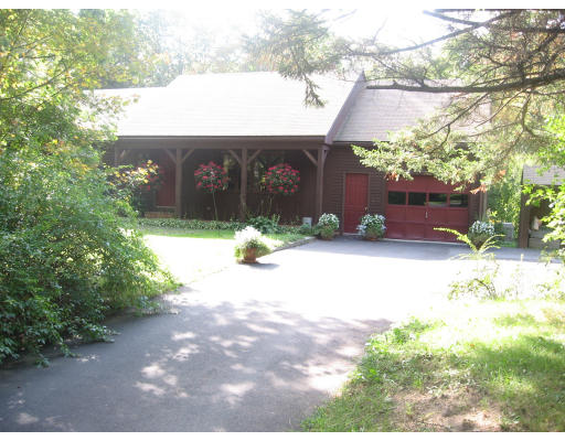 142 Center Road Shirley, MA 01464 - Photo 2 of 12 a front view of a house with a yard and a garage