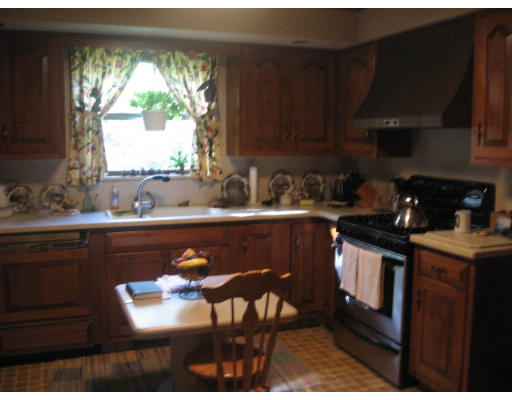 142 Center Road Shirley, MA 01464 - Photo 8 of 12 a kitchen with a sink a stove cabinets and a dining table