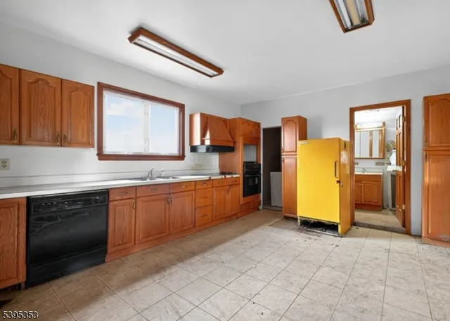 a kitchen with stainless steel appliances granite countertop a sink cabinets and window