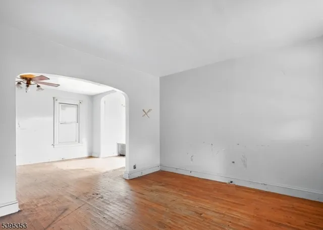 a view of a room with wooden floor