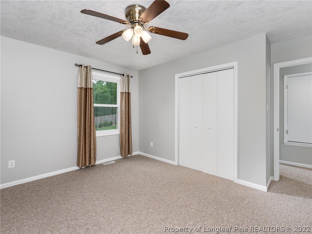 452 Saddle Ridge Road Fayetteville, NC 28311 - Photo 28 of 37 an empty room with chandelier fan