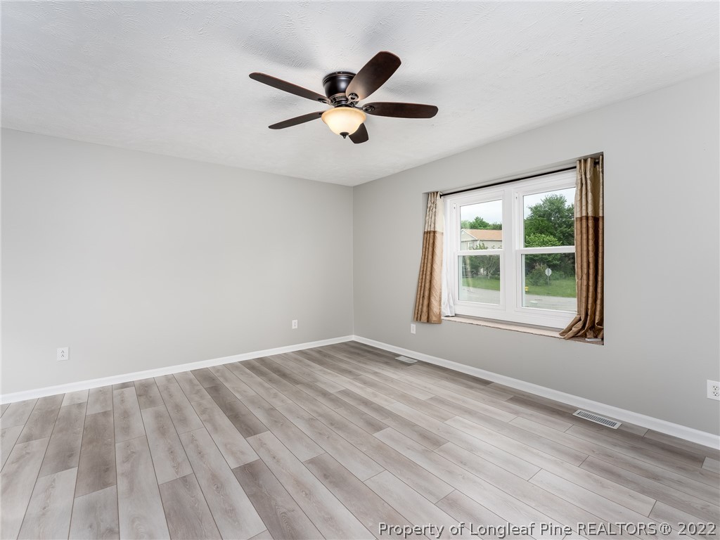 452 Saddle Ridge Road Fayetteville, NC 28311 - Photo 6 of 37 a view of empty room with wooden floor and fan