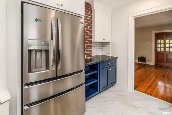 a kitchen with stainless steel appliances granite countertop a refrigerator and a stove