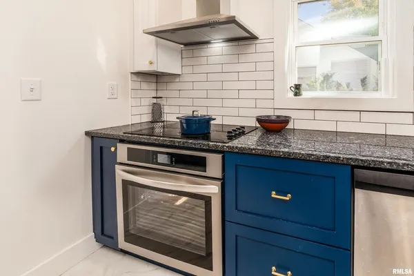 a kitchen with stainless steel appliances granite countertop a sink stove and cabinets