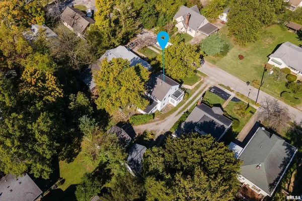 an aerial view of a house with a yard and garden