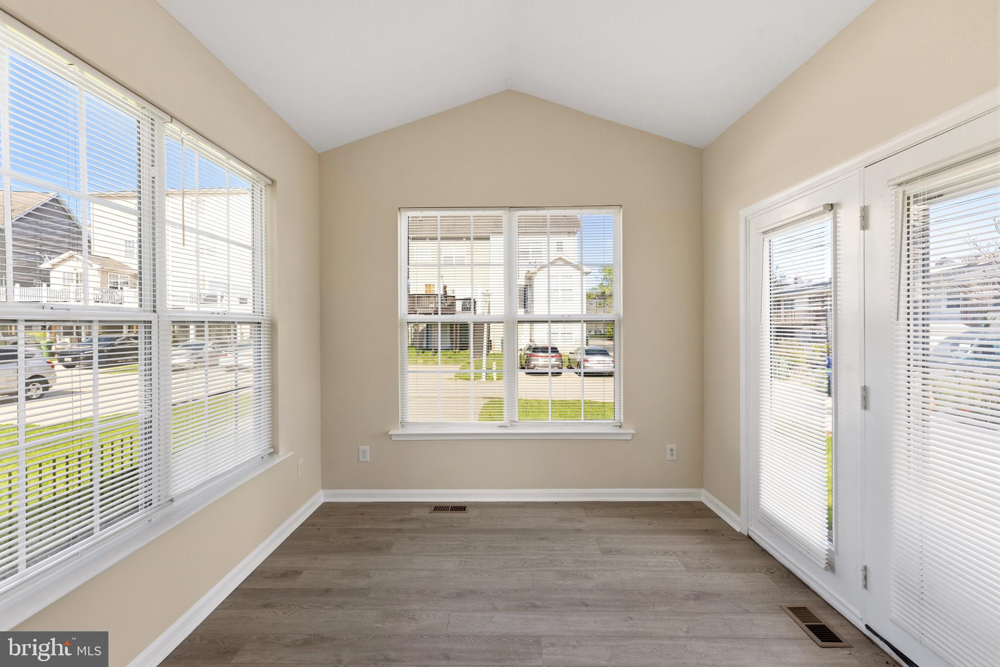 4704 Denview Way Baltimore, MD 21206 - Photo 9 of 42 an empty room with wooden floor and windows