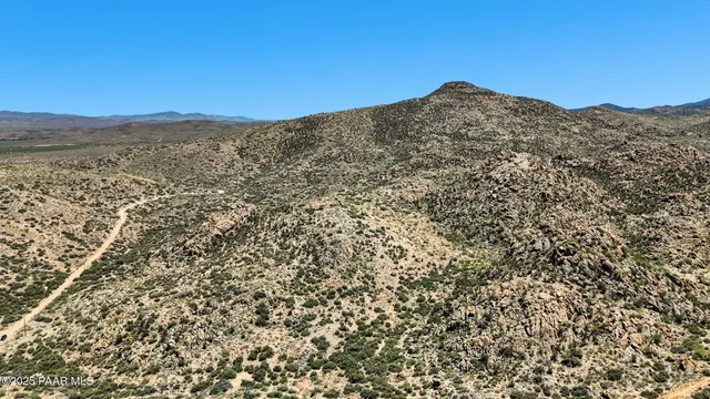 a view of a large mountain with a mountain in the background