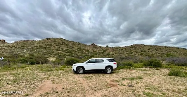 a view of a large building with mountains in the background